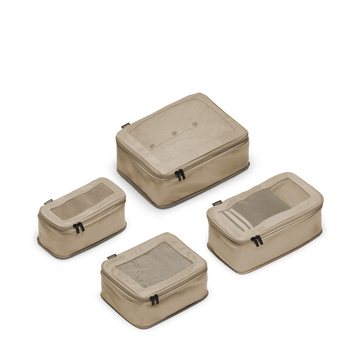 This is a photo of a set of four compressible packing cubes in tan
