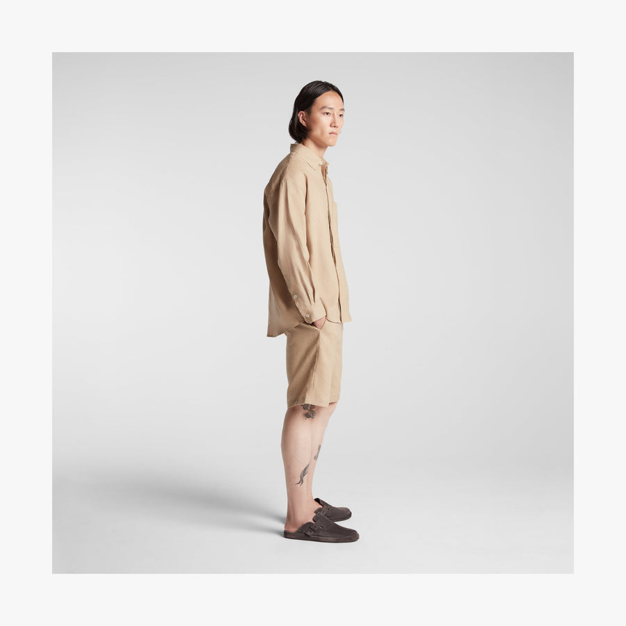 Cliff Stone | Full body side view of man in Algarve Shirt in Cliff Stone