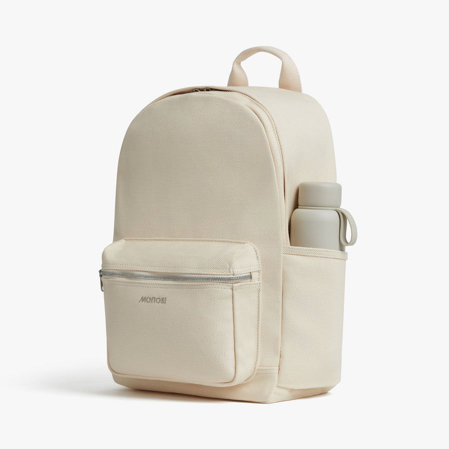 Ecru | Side exterior pocket view of Gesso Backpack in Ecru