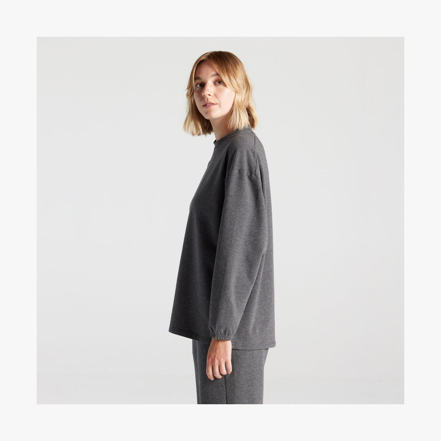 Heather Charcoal | Side view of female in Kyoto Long Sleeve in Heather Charcoal