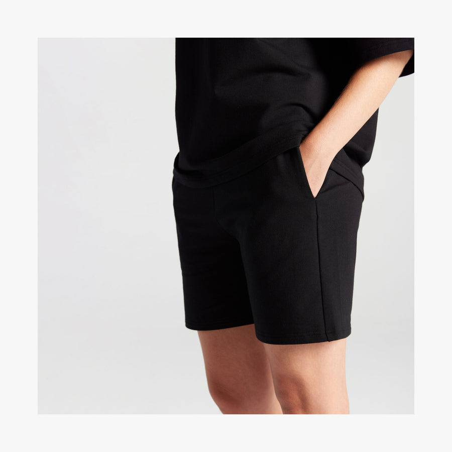 Black | Side pocket view of woman in Kyoto Shorts in Black