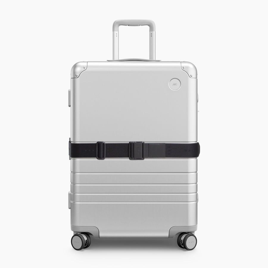 Midnight Black | Front view of Aluminum suitcase with the Midnight Black Luggage Strap secured around it