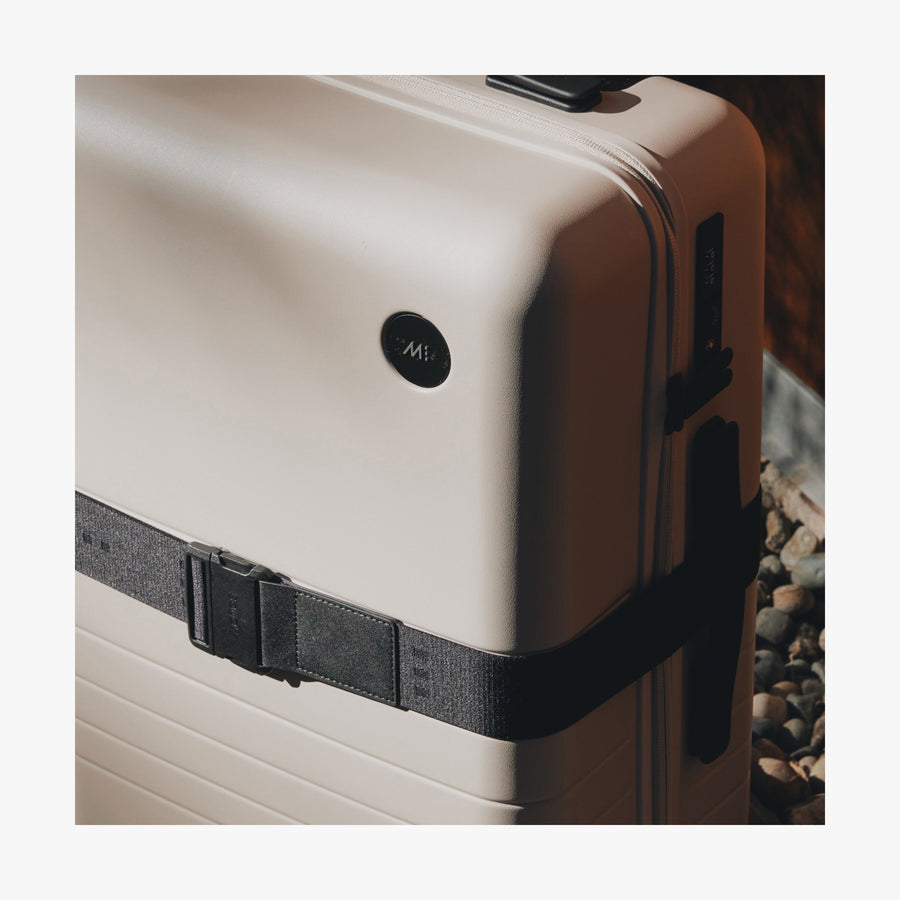 Midnight Black | Close-up view of a suitcase with the Midnight Black Luggage Strap secured around it showing the fabric details and buckle