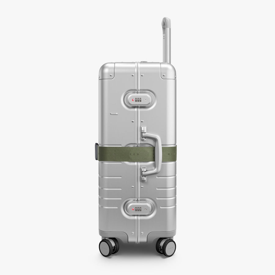 Olive Green | Side view of Aluminum suitcase with the Olive Green Luggage Strap secured around it