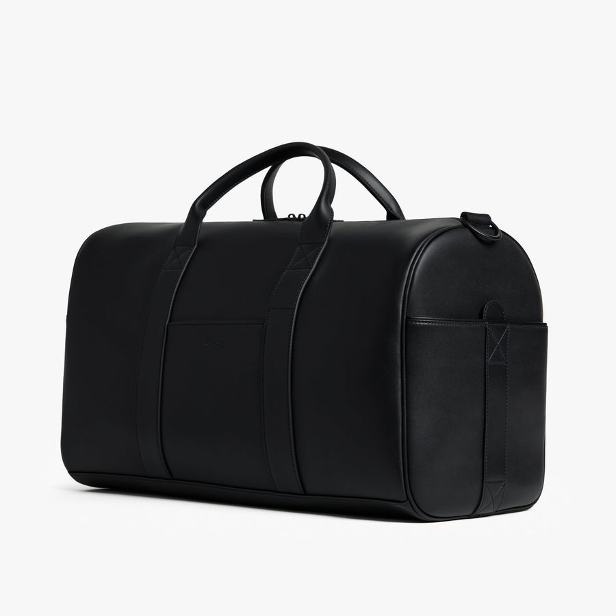 Carbon Black (Vegan Leather) | Angled view of Metro Carry-All Duffel in Carbon Black