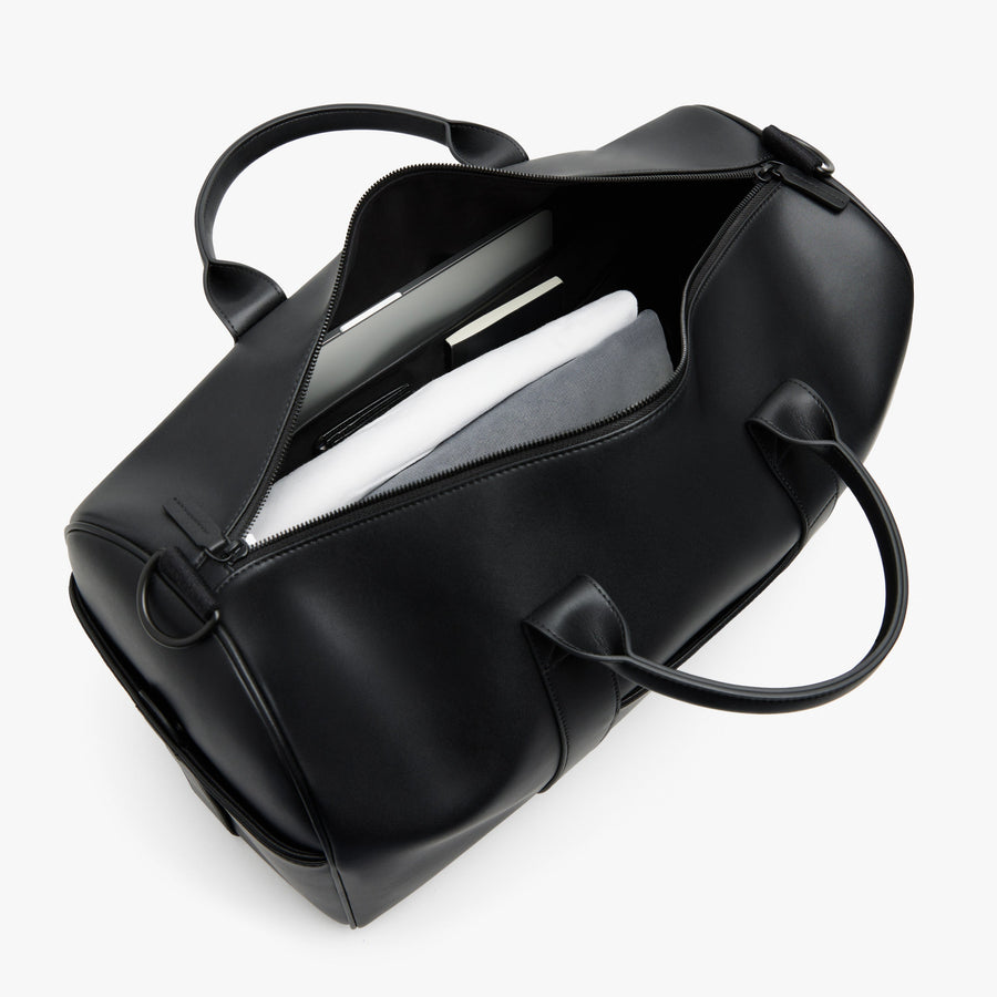 Carbon Black (Vegan Leather) | Angled view of Metro Carry-All Duffel in Carbon Black