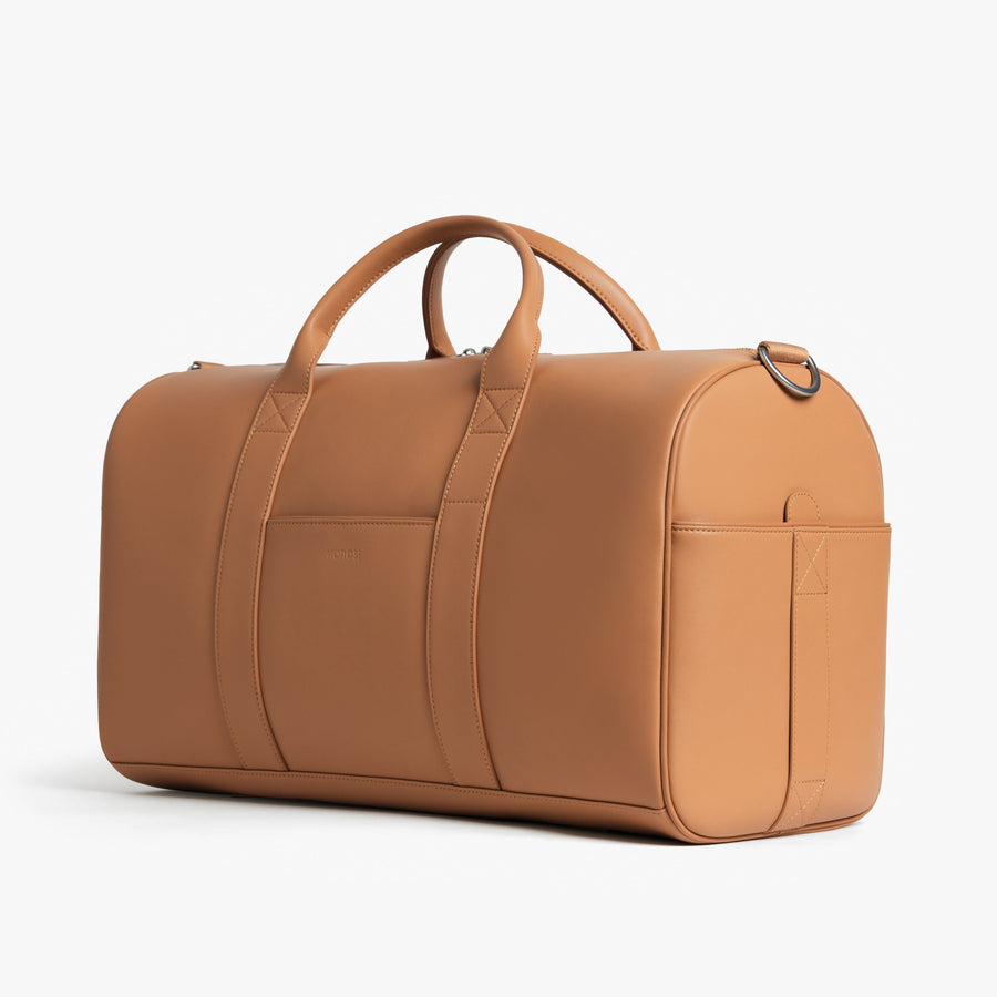 Saddle Tan (Vegan Leather) | Angled view of Metro Carry-All Duffel in Saddle Tan