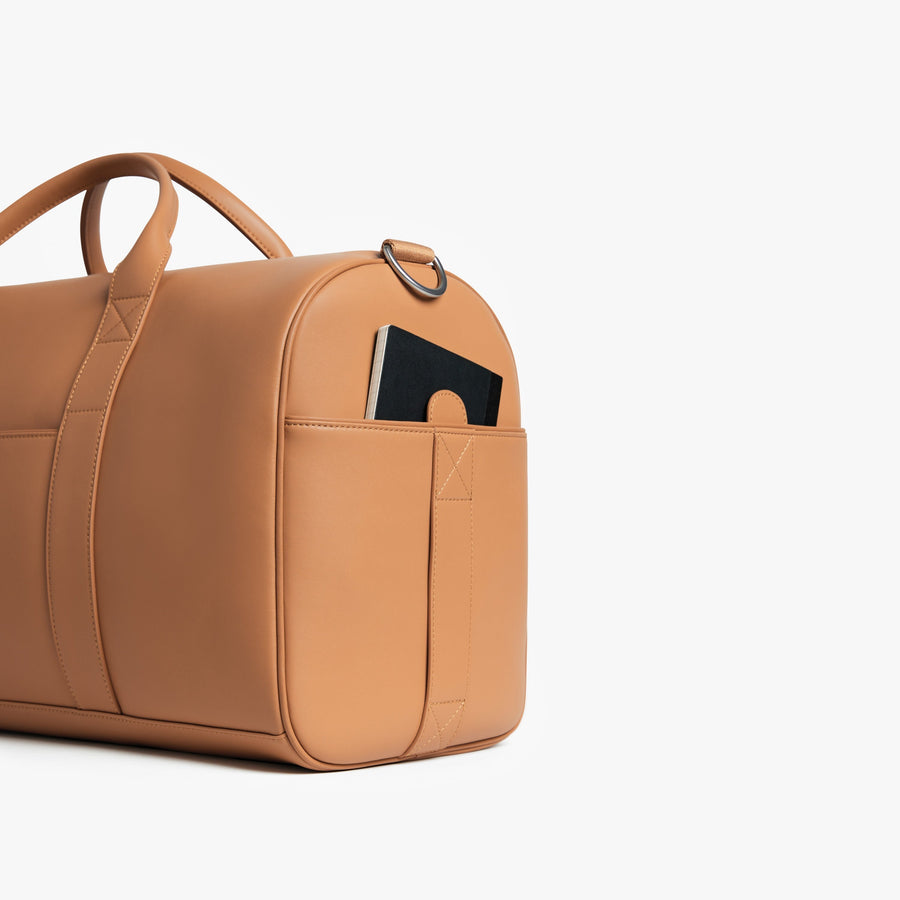 Saddle Tan (Vegan Leather) | Angled view of Metro Carry-All Duffel in Saddle Tan