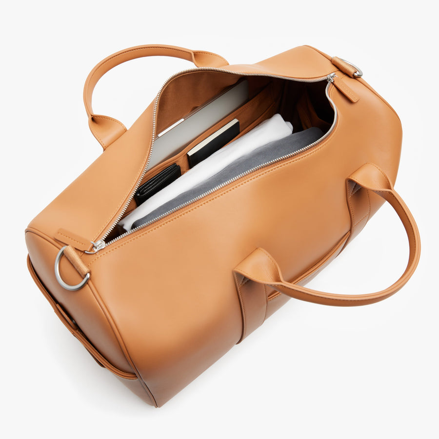 Saddle Tan (Vegan Leather) | Angled view of Metro Carry-All Duffel in Saddle Tan