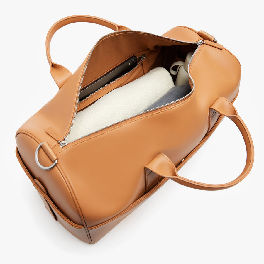 Saddle Tan (Vegan Leather) | Angled view of Metro Carry-All Duffel in Saddle Tan