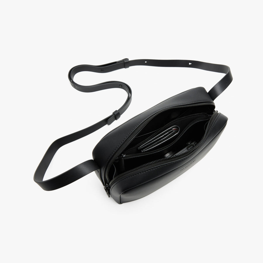 Carbon Black (Vegan Leather) | Angled view of Metro Crossbody in Carbon Black