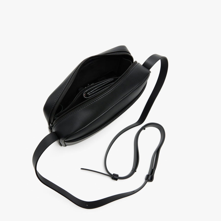 Carbon Black (Vegan Leather) | Angled view of Metro Crossbody in Carbon Black