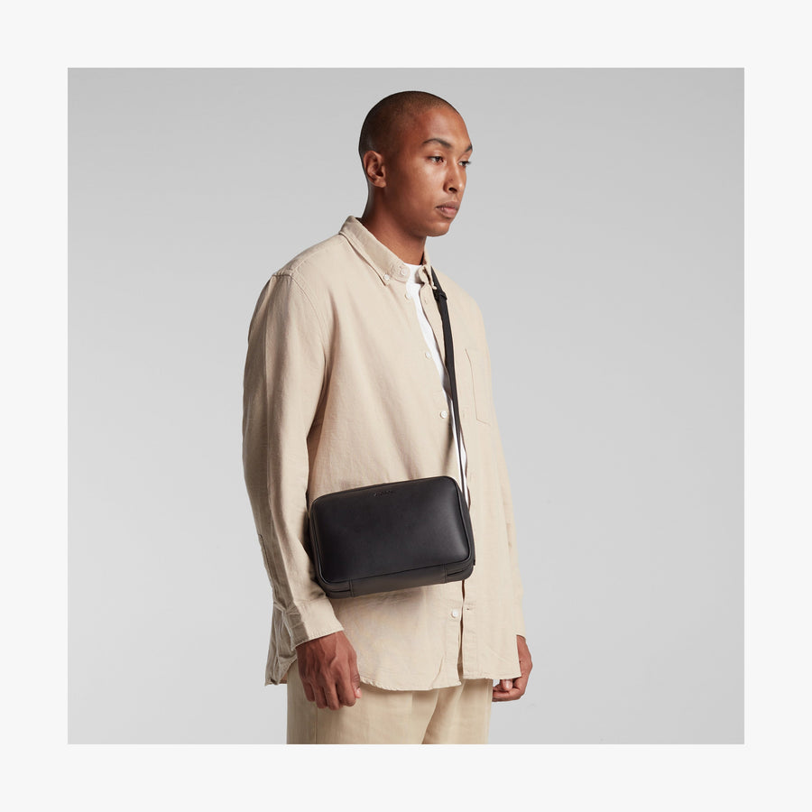 Carbon Black (Vegan Leather) | Angled view of Metro Crossbody in Carbon Black