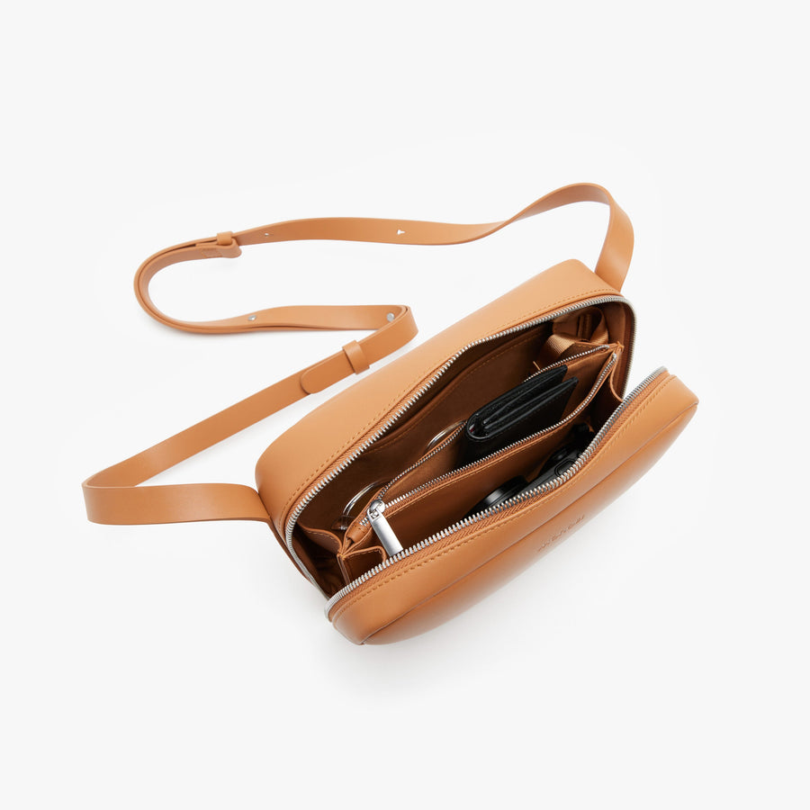 Saddle Tan (Vegan Leather) | Angled view of Metro Crossbody in Saddle Tan