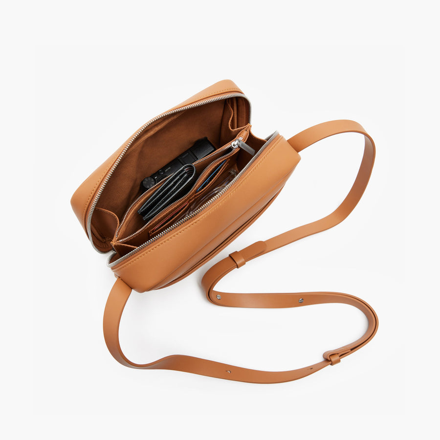 Saddle Tan (Vegan Leather) | Angled view of Metro Crossbody in Saddle Tan