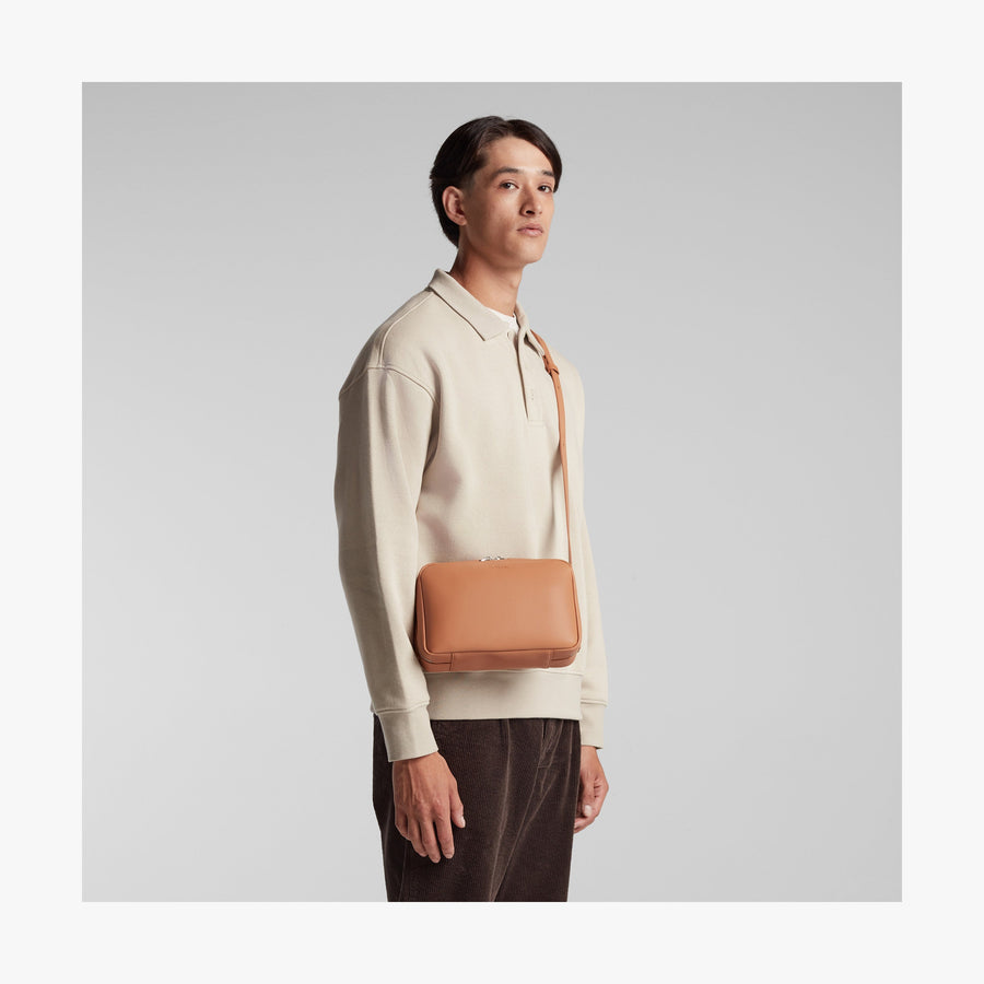 Saddle Tan (Vegan Leather) | Angled view of Metro Crossbody in Saddle Tan