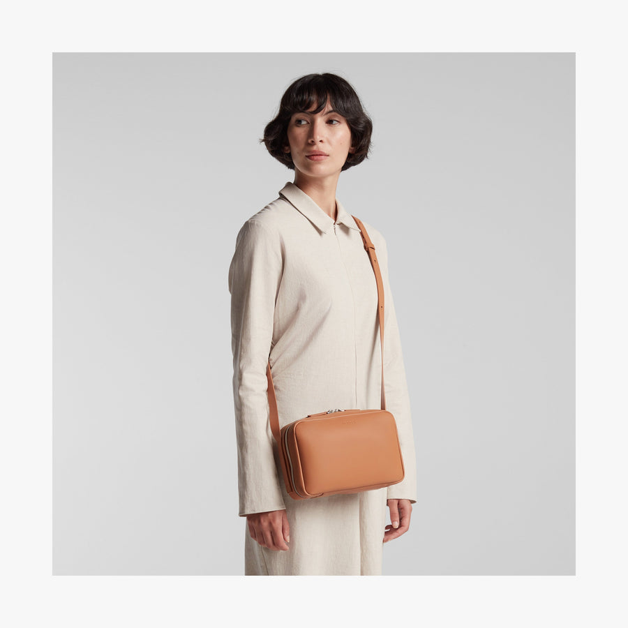 Saddle Tan (Vegan Leather) | Angled view of Metro Crossbody in Saddle Tan