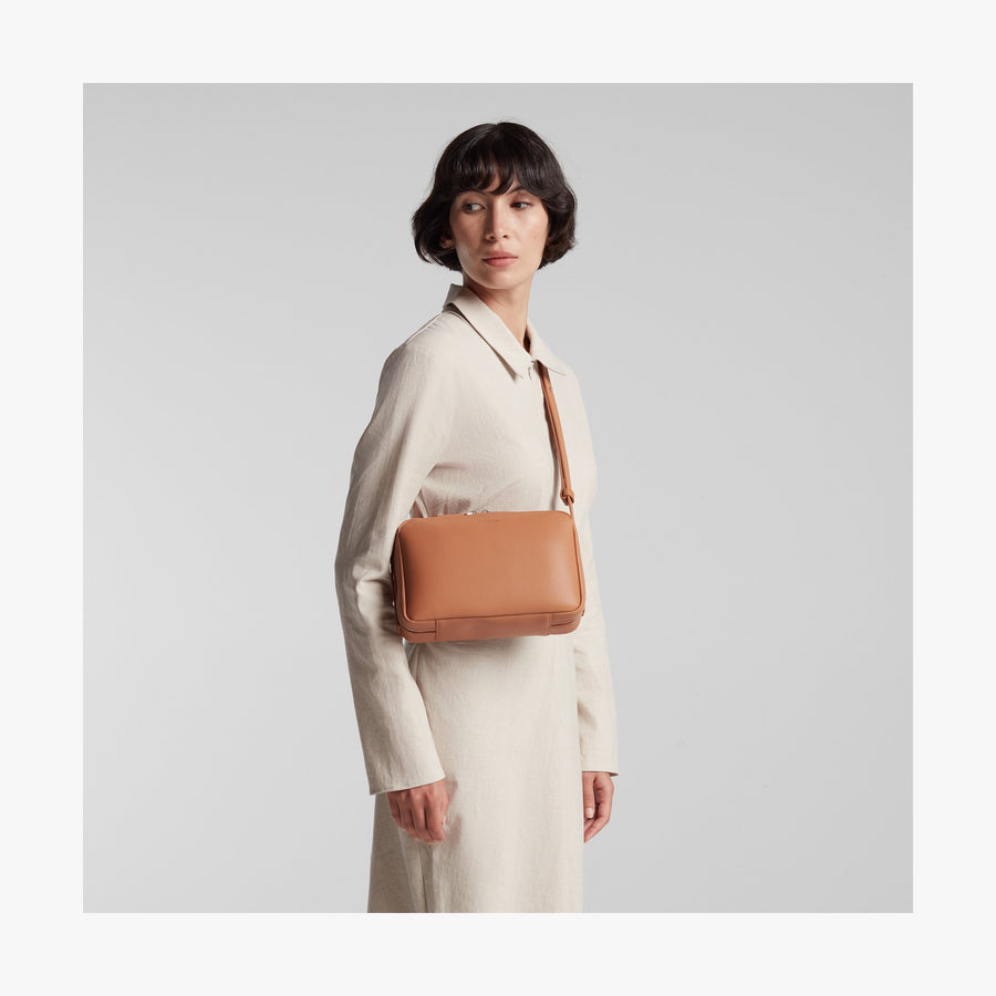 Saddle Tan (Vegan Leather) | Angled view of Metro Crossbody in Saddle Tan