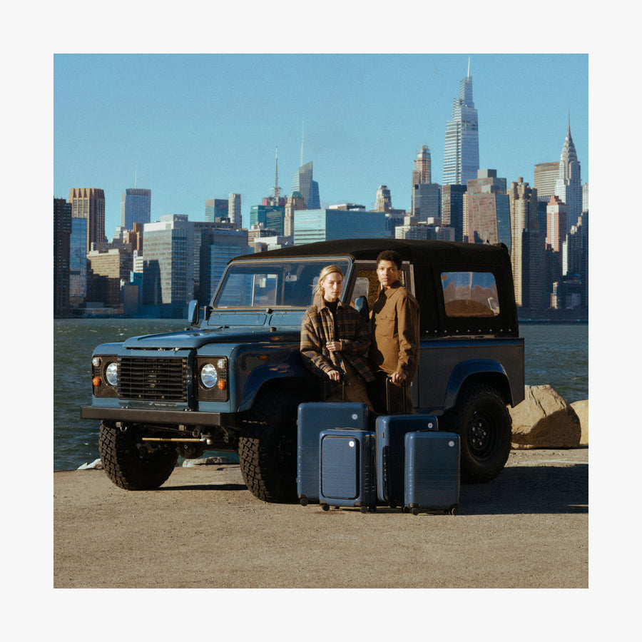 Arles Blue (Glossy) | Couple with Arles Blue suitcases by a car in New York City