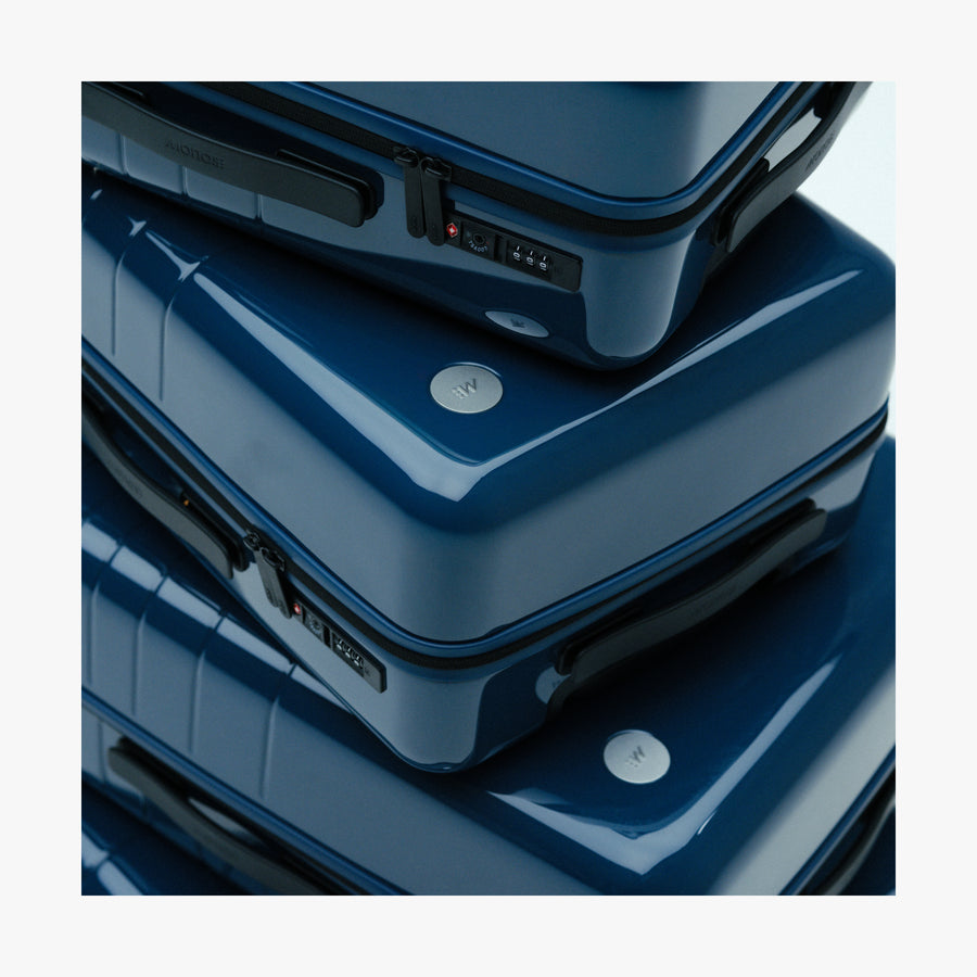 Arles Blue (Glossy) | Stacked Arles Blue suitcases in different sizes