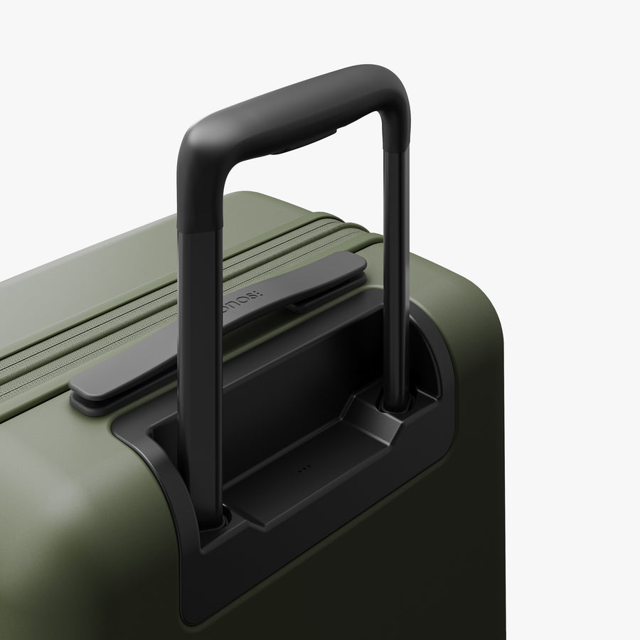 Olive Green | Extended luggage handle view of Expandable Carry-On Pro in Olive Green