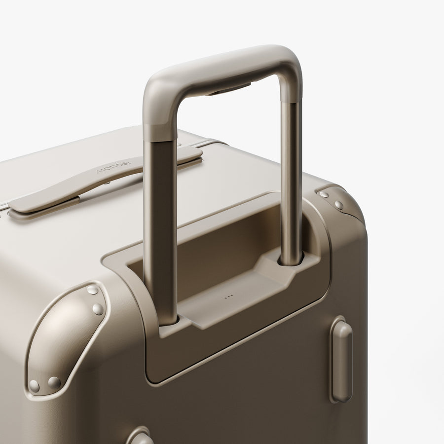 Champagne | Extended luggage handle view of Hybrid Trunk Medium in Champagne
