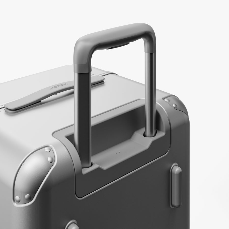 Silver | Extended luggage handle view of Hybrid Trunk Medium in Silver