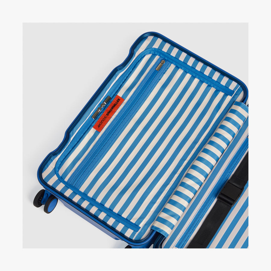 Coastal Blue | Interior view of a Hybrid suitcase in Coastal Blue featuring the Poplin Stripe Coastal Blue zipped compartment
