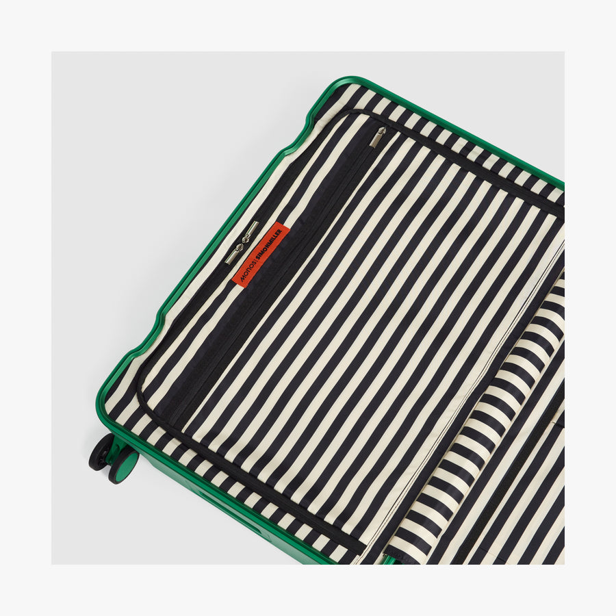 Jungle Green | Interior view of a Hybrid suitcase in Jungle Green featuring the Poplin Stripe Jungle Green zipped compartment