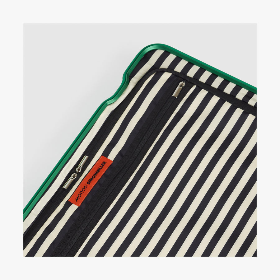 Jungle Green | Close-up view of the Hybrid suitcase interior in Jungle Green, featuring the Poplin Stripe Jungle Green zipped compartment