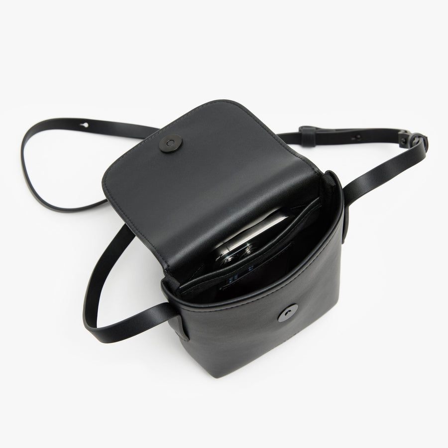 Carbon Black (Vegan Leather) | Angled view of Metro Mini Crossbody in Carbon Black