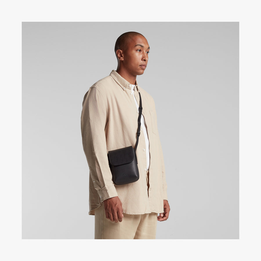 Carbon Black (Vegan Leather) | Angled view of Metro Mini Crossbody in Carbon Black