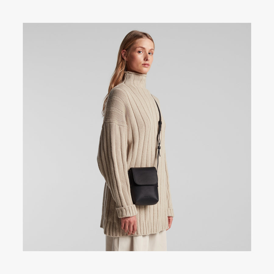 Carbon Black (Vegan Leather) | Angled view of Metro Mini Crossbody in Carbon Black