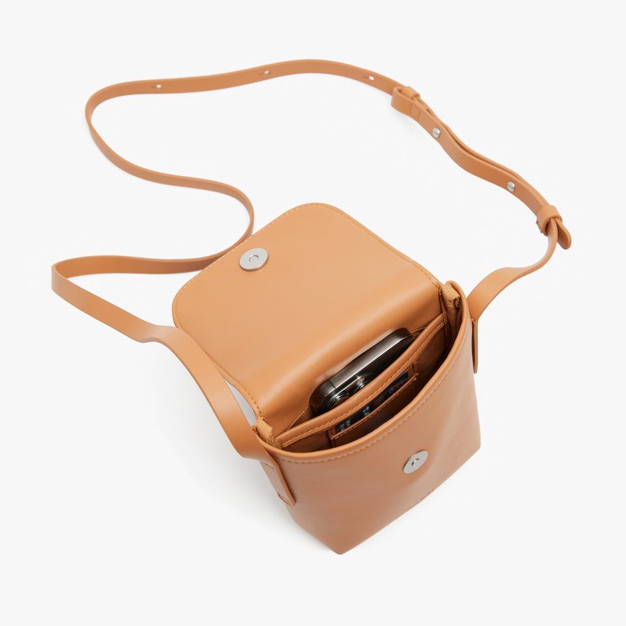 Saddle Tan (Vegan Leather) | Angled view of Metro Mini Crossbody in Saddle Tan