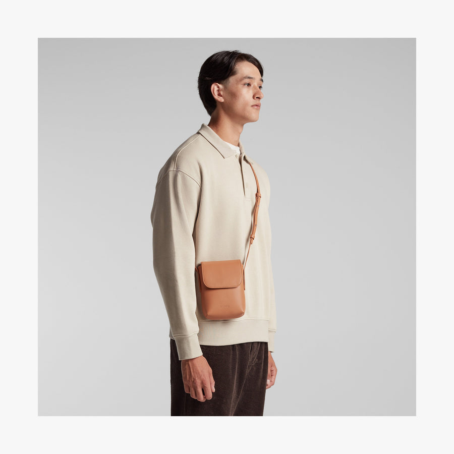 Saddle Tan (Vegan Leather) | Angled view of Metro Mini Crossbody in Saddle Tan