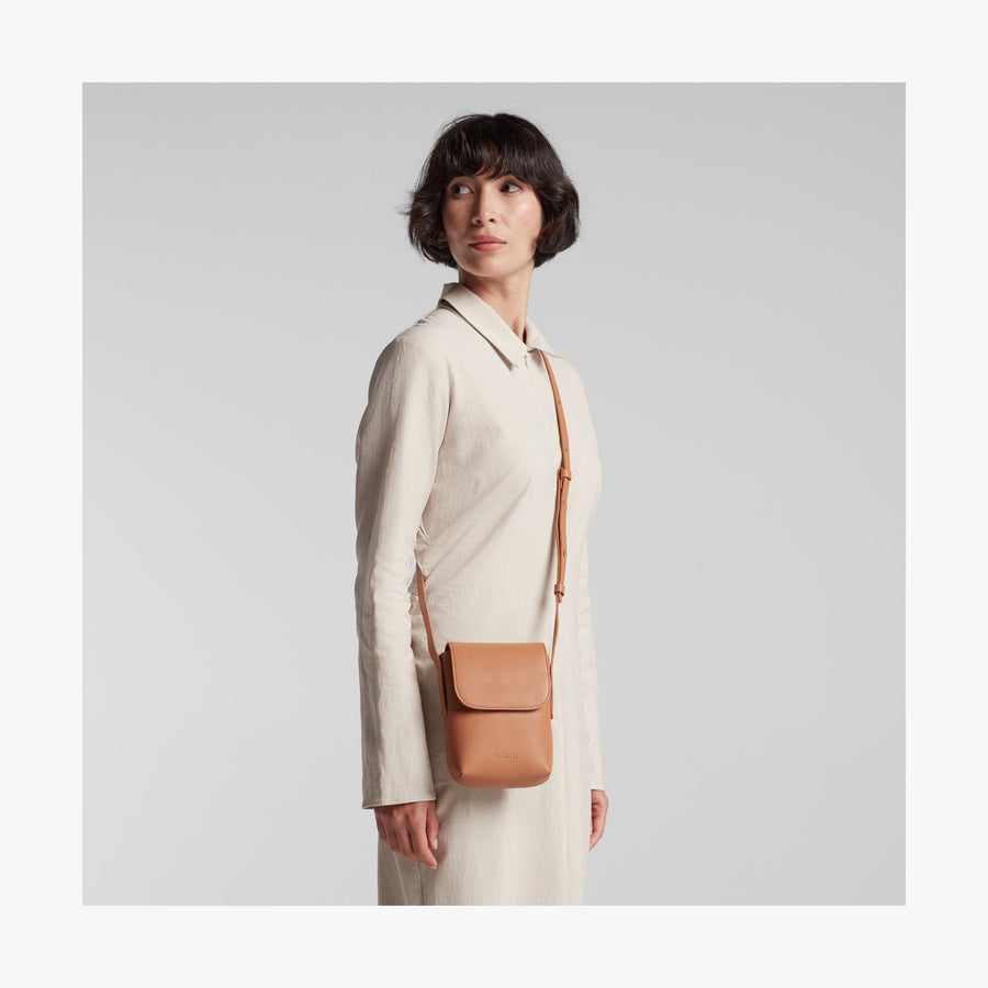 Saddle Tan (Vegan Leather) | Angled view of Metro Mini Crossbody in Saddle Tan