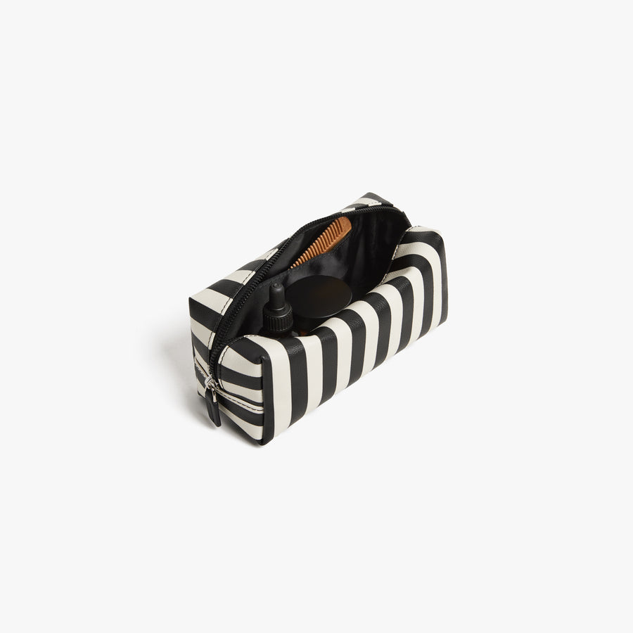 Small / Poplin Stripe Black | Back angled view of the opened small Metro Toiletry Case in Poplin Stripe Black, showing travel essentials stored inside