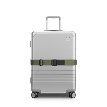 Front view of Aluminum suitcase with the Olive Green Luggage Strap secured around it