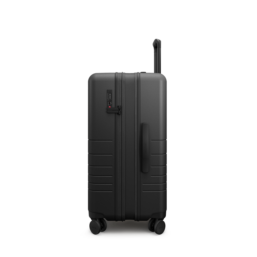 Midnight Black Hover | Side view of Expandable Check-In Medium in Midnight Black