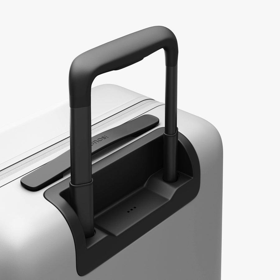 Stellar White | Extended luggage handle view of Carry-On Plus in Stellar White