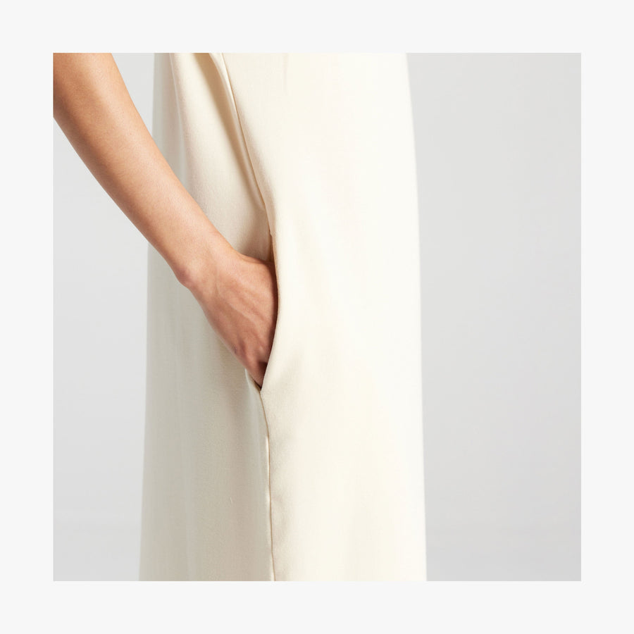 Cream | Side pocket view of woman in Sevilla Dress Cream