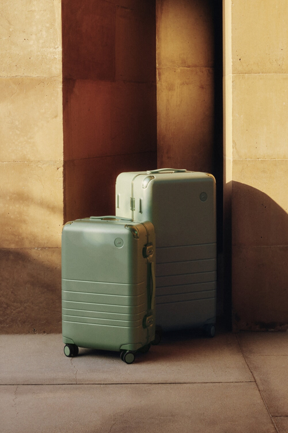 The Hybrid Carry-On and Hybrid Trunk in Mint, captured in soft light and quiet shadows.