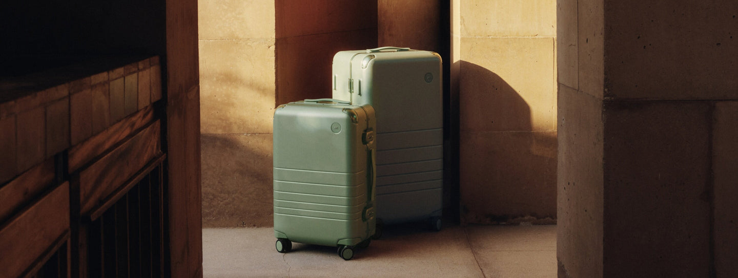 The Hybrid Carry-On and Hybrid Trunk in Mint, captured in soft light and quiet shadows.